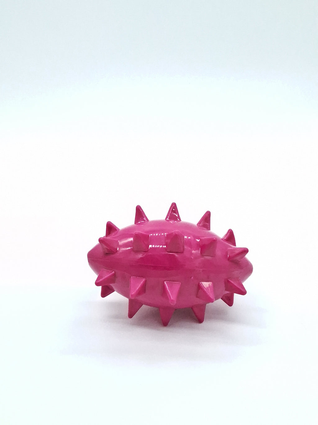 Pink spiky dog toy for chewing and playing, durable pet accessory for dogs