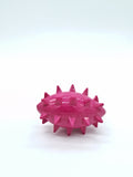 Pink spiky dog toy for chewing and playing, durable pet accessory for dogs