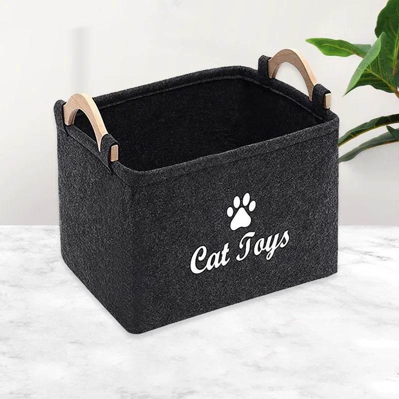 Black felt cat toy storage bin with wooden handles and paw print design, ideal for pet accessories and organization