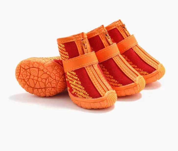 Orange and red dog booties with zipper and grip sole for pet paw protection