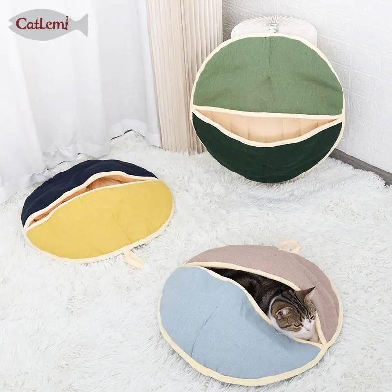 Cozy cat cave beds in green, navy, and blue with a tabby cat resting inside, perfect for pet comfort.