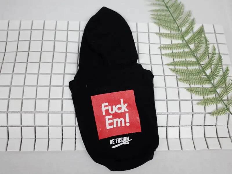 Black pet hoodie with red 'Fuck Em!' graphic, stylish dog apparel on tiled background with fern leaf