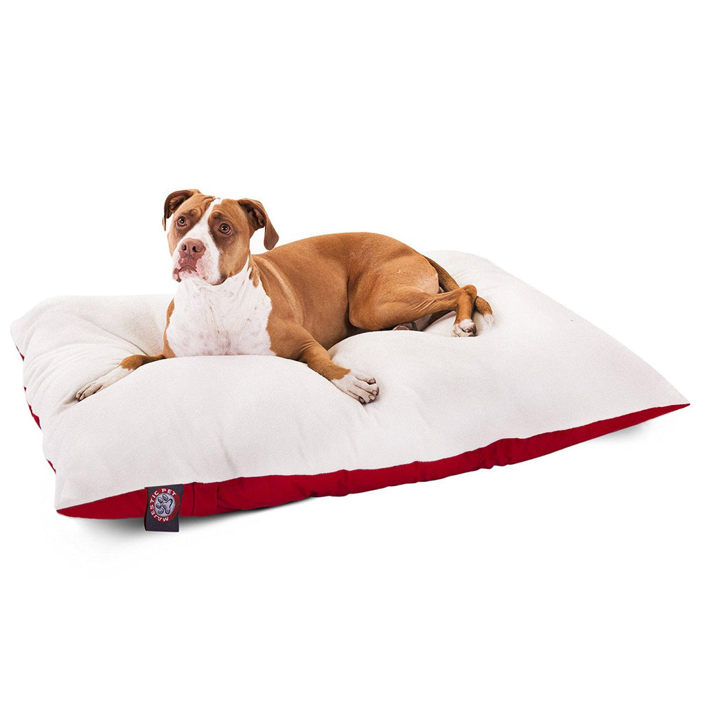 Brown and white dog resting on cozy white dog bed with red trim, perfect for pet comfort and care.