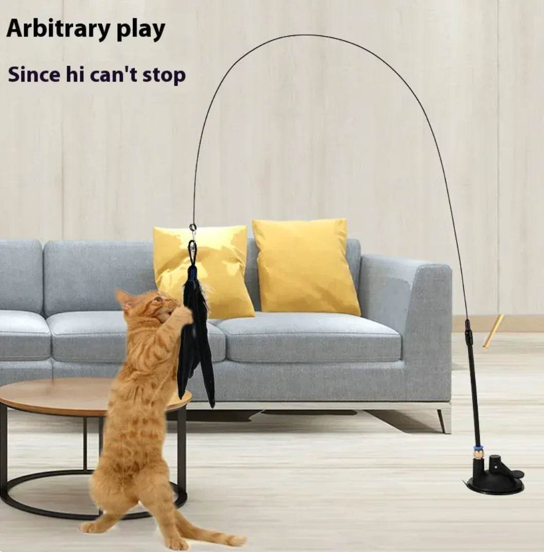 Orange cat playing with feather wand toy on stand, interactive pet accessory for indoor cats