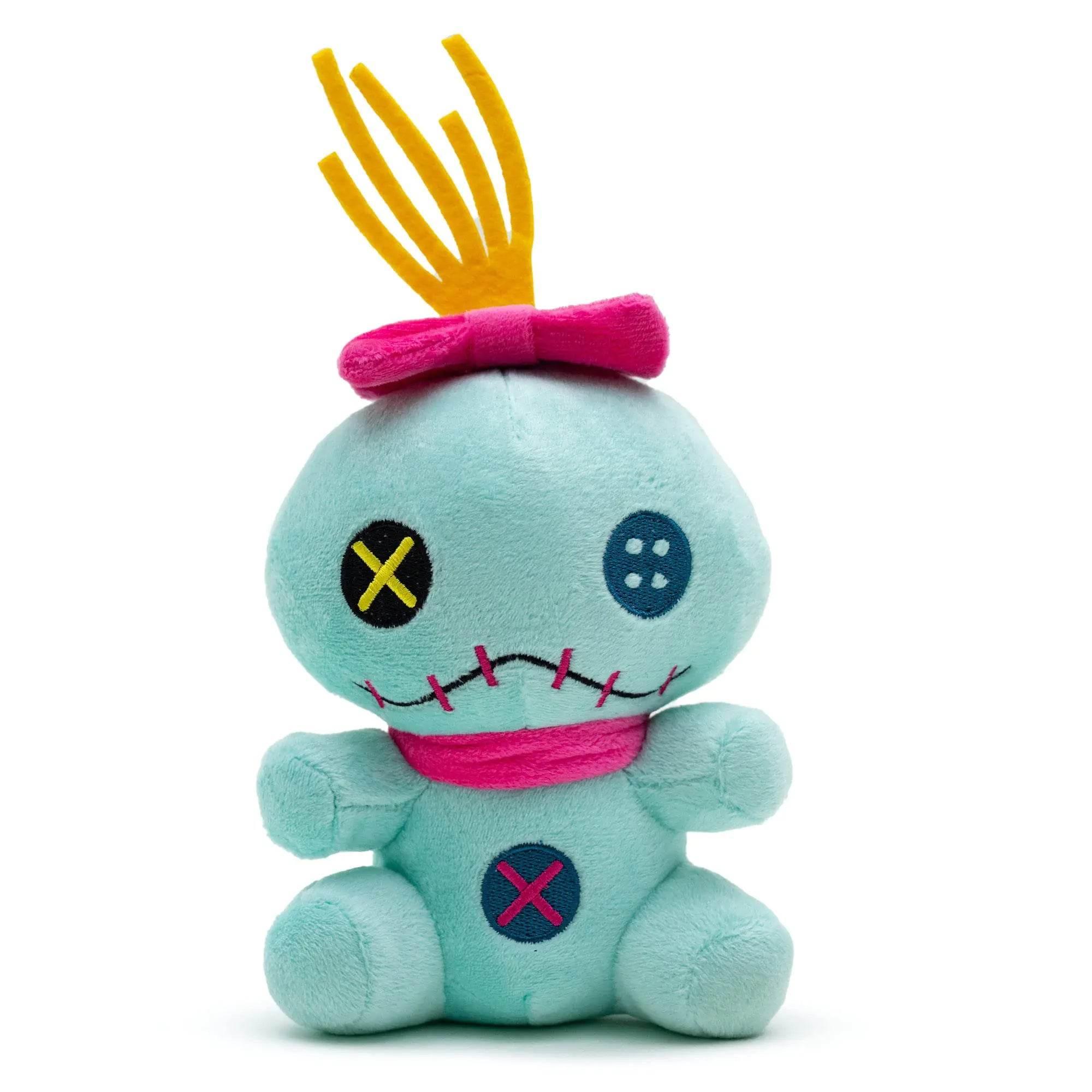 Teal plush voodoo doll pet toy with yellow hair, pink bow, and stitched details for dogs and cats