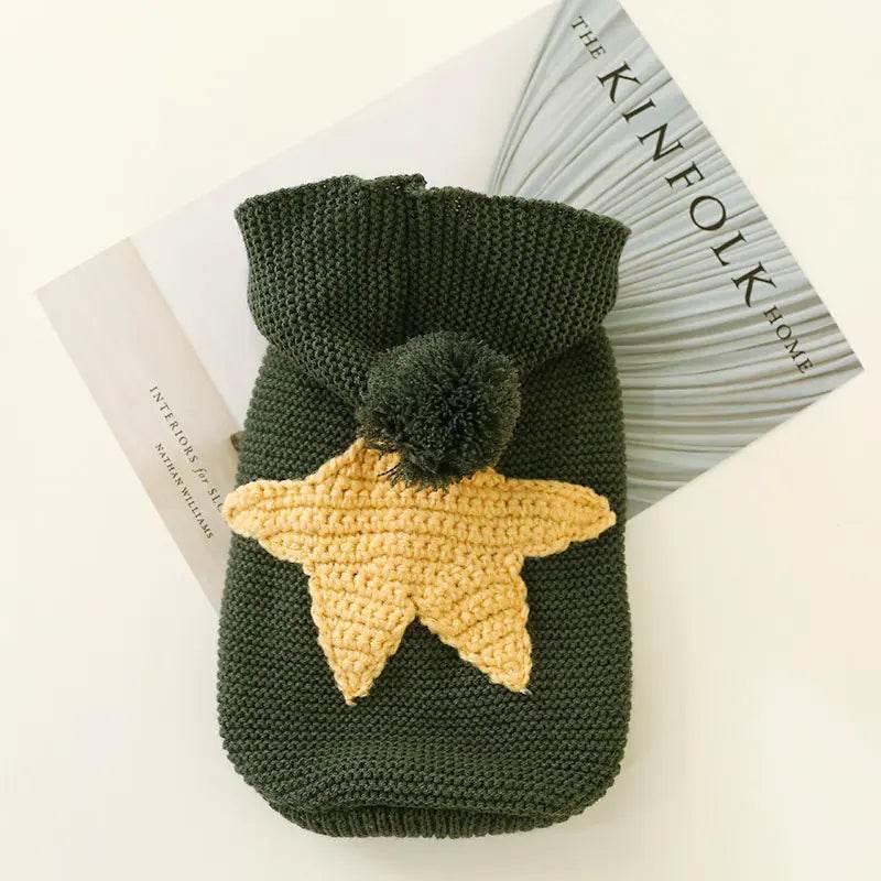 Green knitted pet sweater with yellow star and pom-pom, cozy dog or cat winter wear