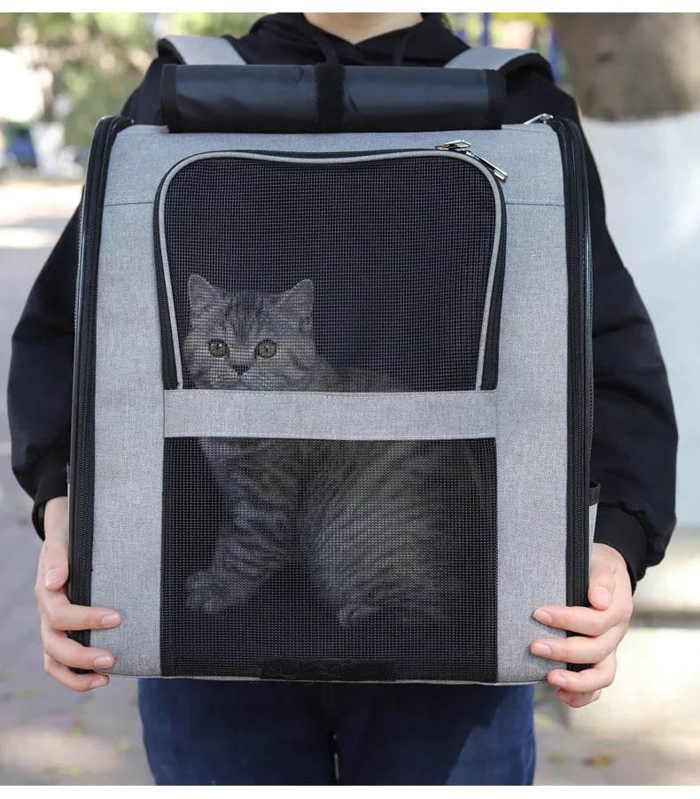 Gray cat carrier backpack with mesh windows, perfect for pet travel and outdoor adventures.