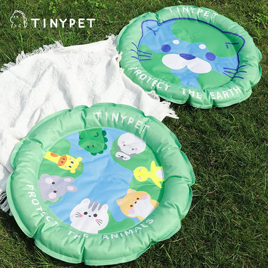 Inflatable pet cooling mats with cute animal designs, perfect for outdoor use on grass.